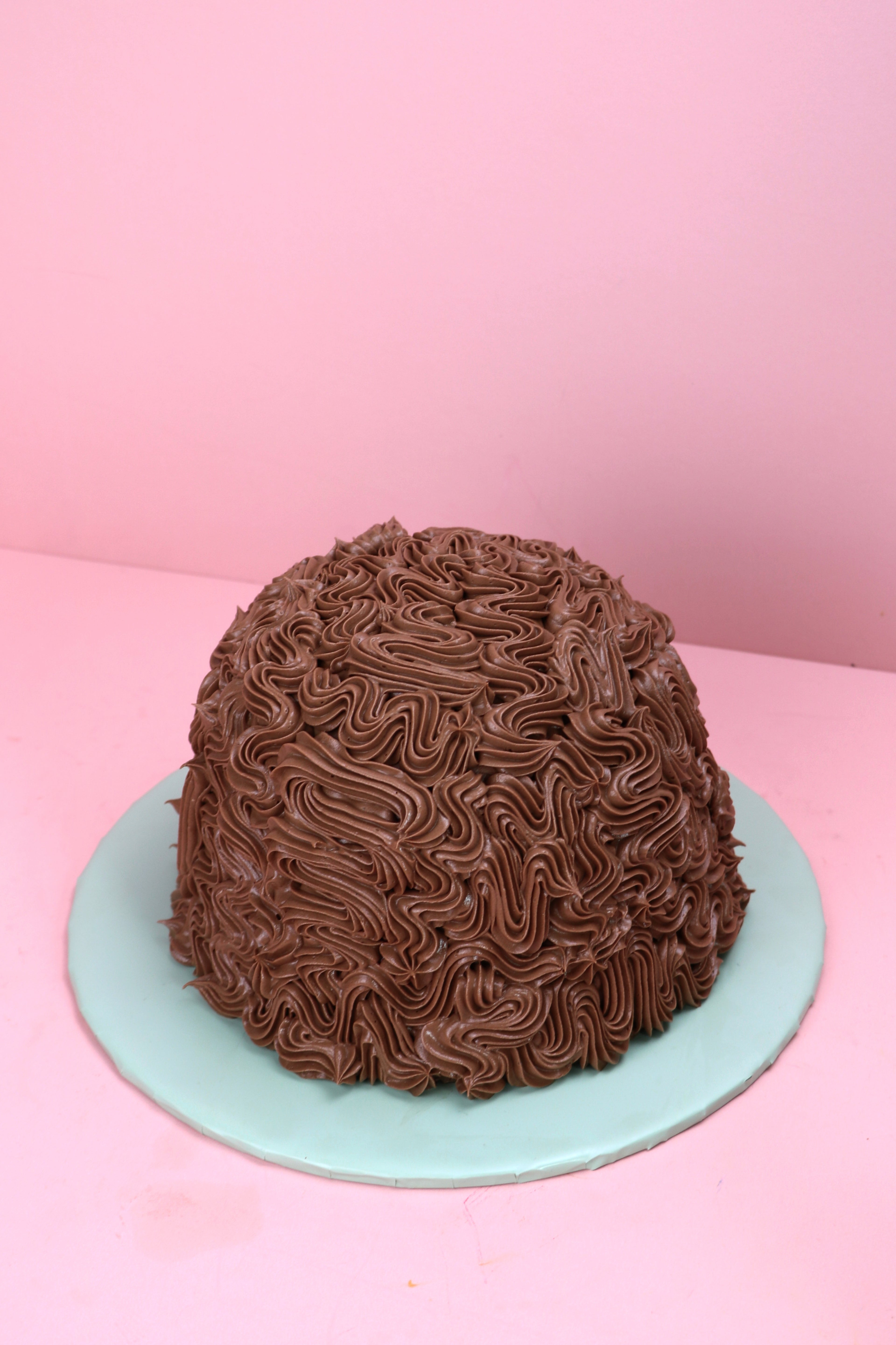 Mint chocolate dome cake with piped chocolate buttercream design, Swirl piped chocolate dome cake with mint buttercream filling, Dome-shaped chocolate cake with rich buttercream texture made by Cakeasion in Uxbridge.