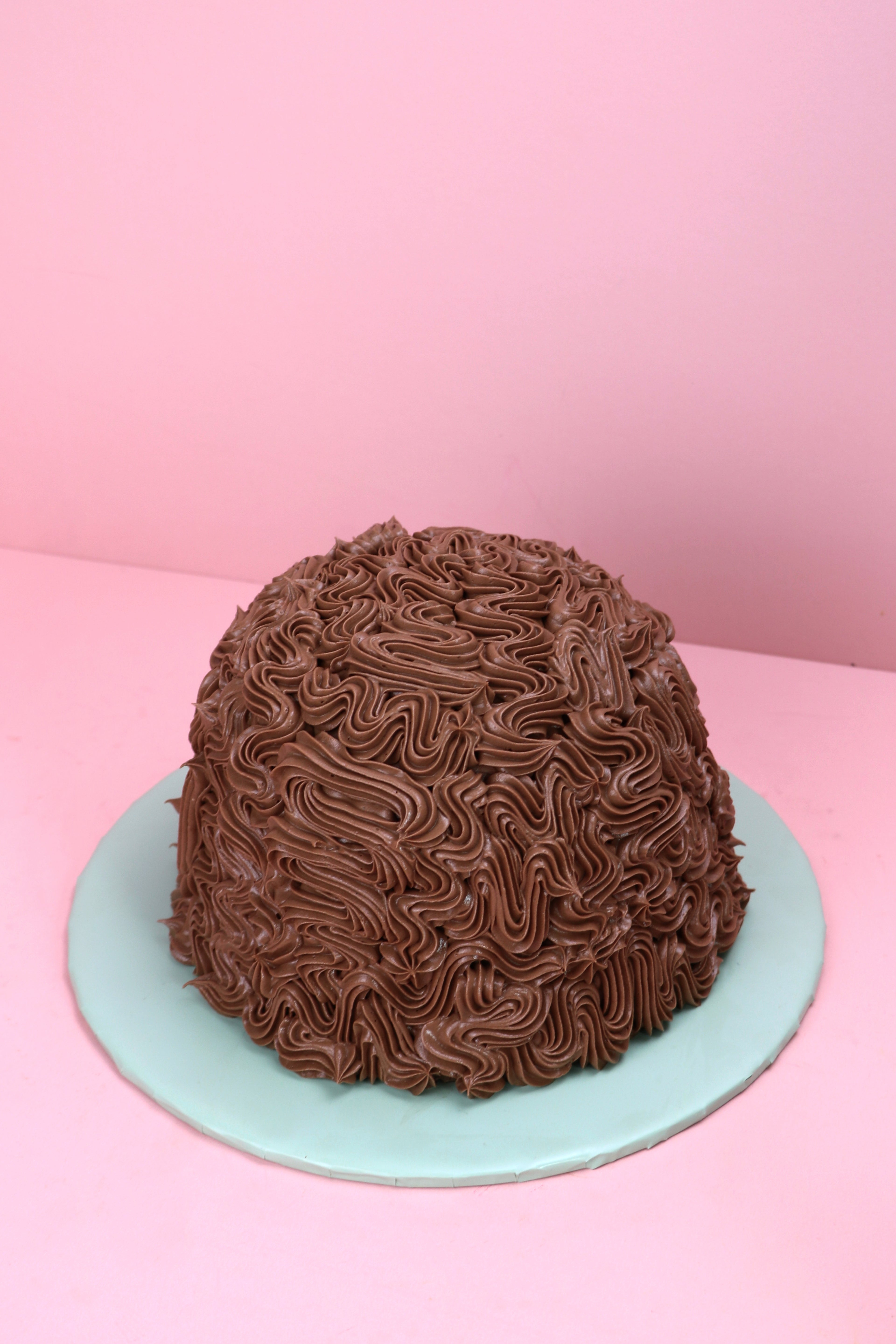 Mint chocolate dome cake with piped chocolate buttercream design, Swirl piped chocolate dome cake with mint buttercream filling, Dome-shaped chocolate cake with rich buttercream texture made by Cakeasion in Uxbridge.