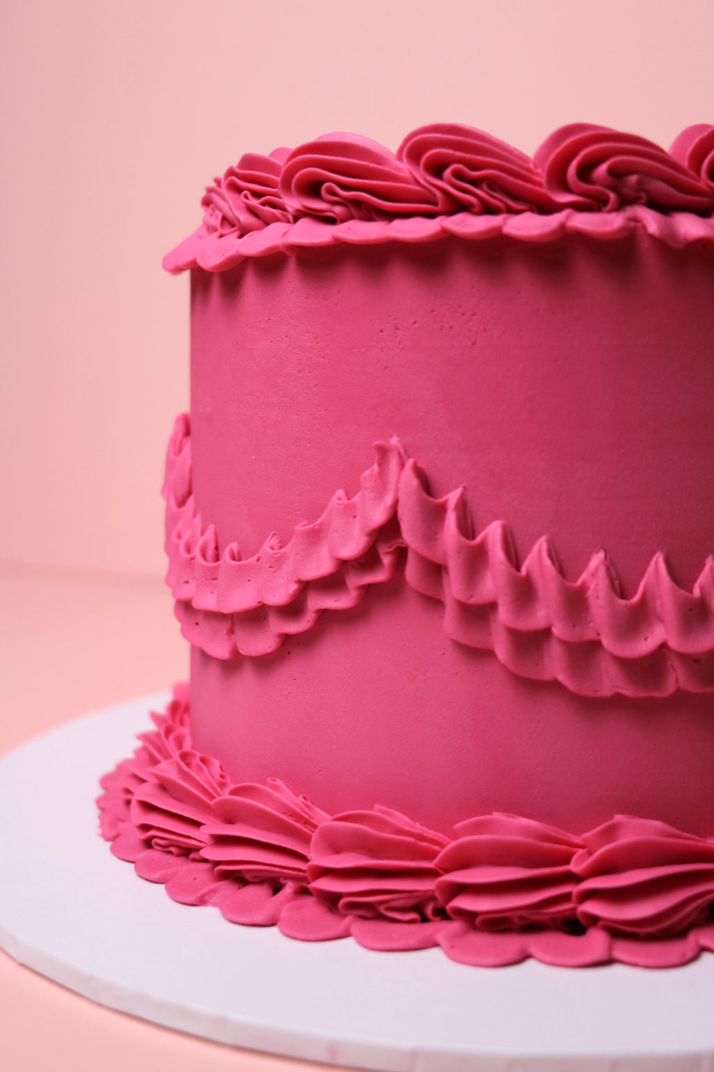 Close-up of pink ruffled buttercream piping on minimalist cake from Cakeasion Shop - serving Uxbridge, Hayes, and surrounding west london areas