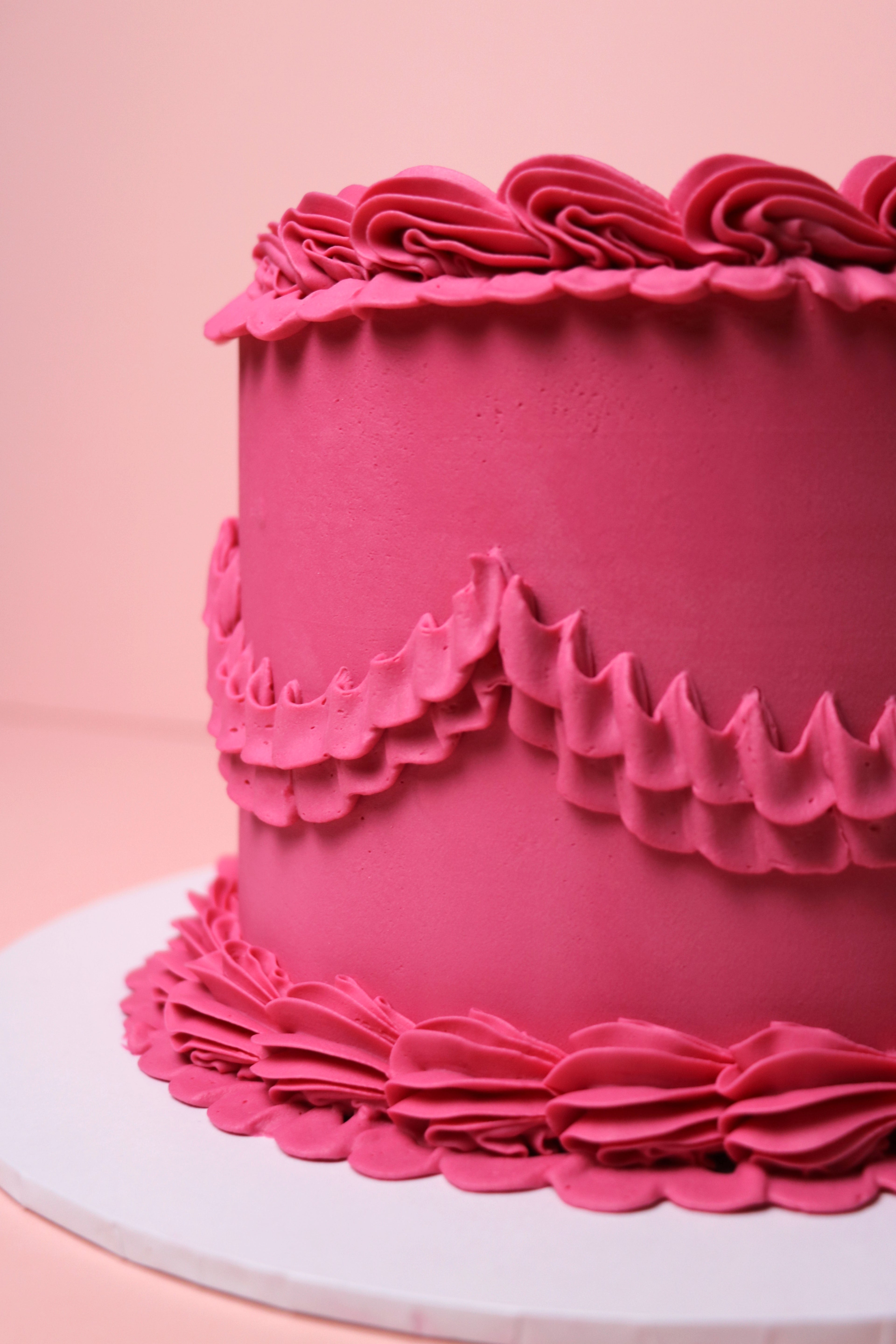 Close-up of pink ruffled buttercream piping on minimalist cake from Cakeasion Shop - serving Uxbridge, Hayes, and surrounding west london areas