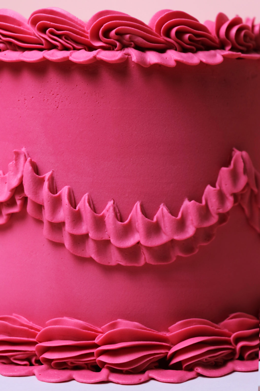 Close-up of decorative pink ruffles buttercream piping on minimalist cake from Cakeasion Shop - serving Uxbridge, Hayes, and surrounding west london areas